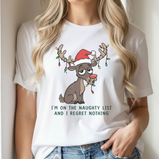 Female model wearing black funny Christmas t-shirt featuring reindeer with Santa hat, standing in modern festive living room.