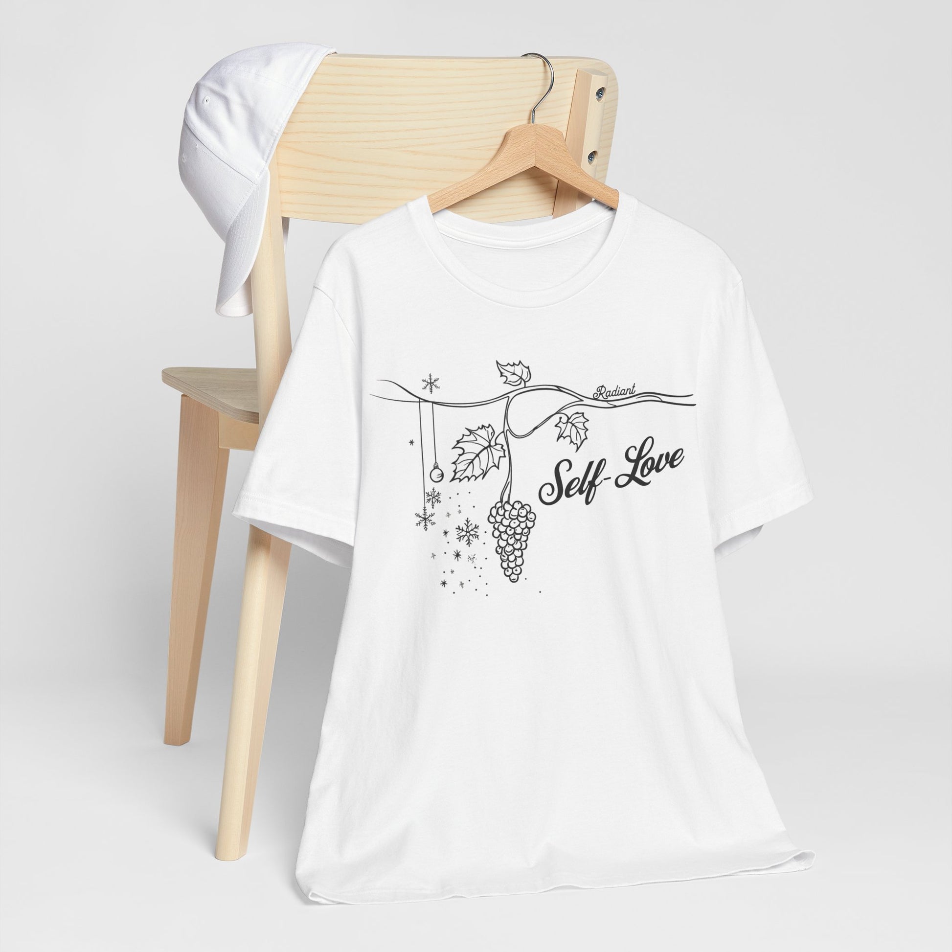 A white t-shirt featuring the phrase "so love" in a stylish design, promoting self-love and positivity.