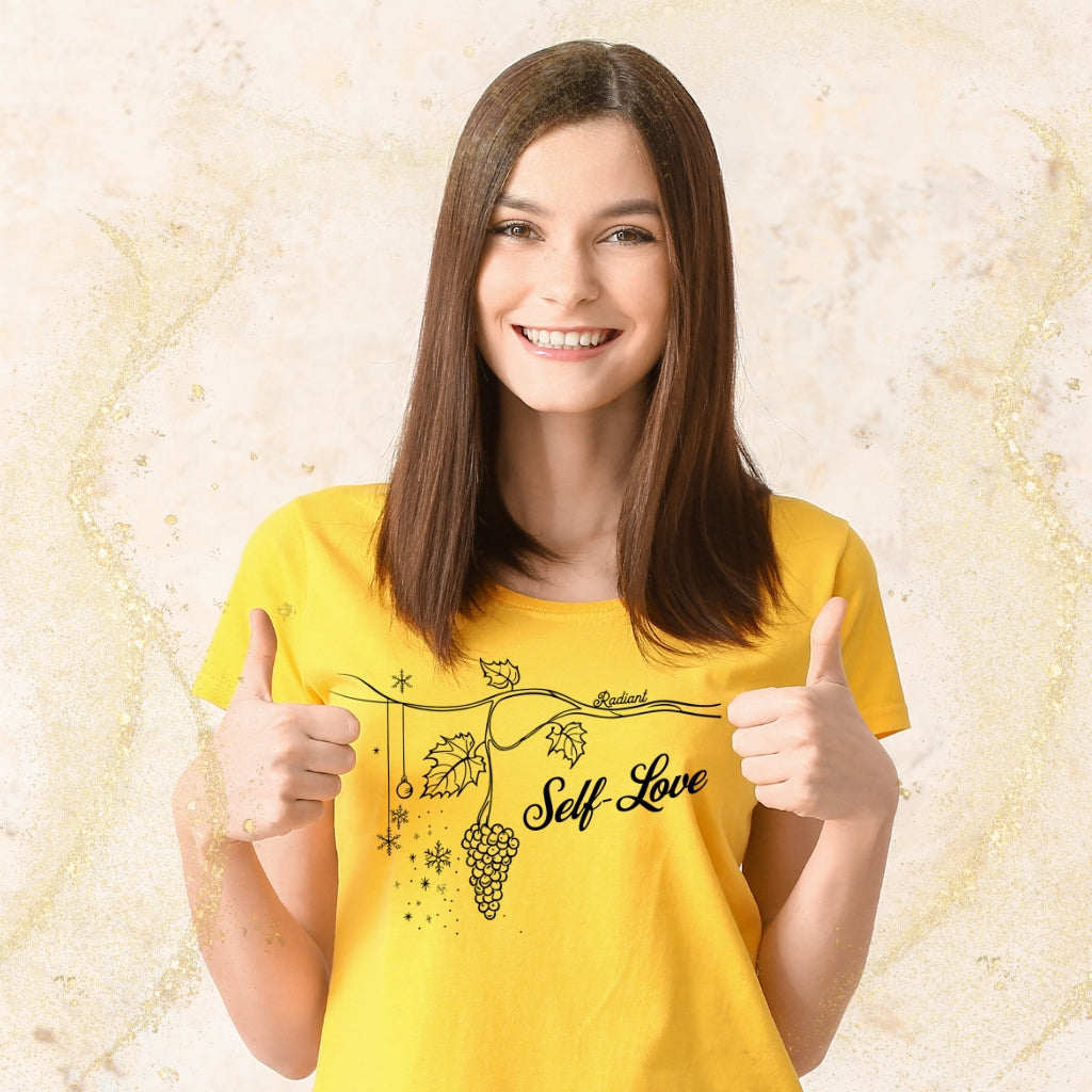 Woman wearing a yellow tee with "Self-Love" and a grapevine graphic, showcasing a minimalist and inspirational style.