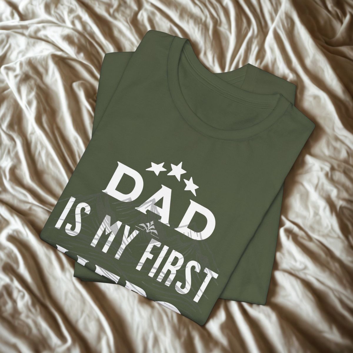 Close-up of the "Dad is my first hero" design on a military green t-shirt.