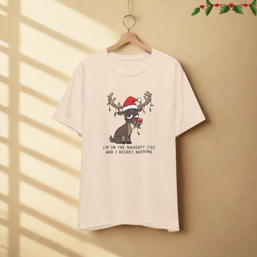 I’m on the Naughty List and I Regret Nothing funny Christmas t-shirt in soft cream color displayed on hanger against neutral background.