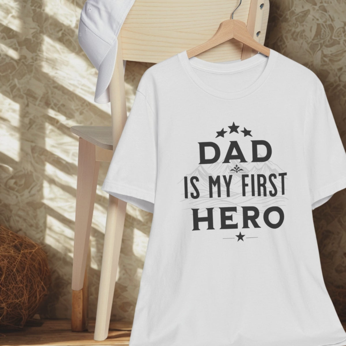 Flat lay of 'Dad Is My First Hero' t-shirt with casual accessories.